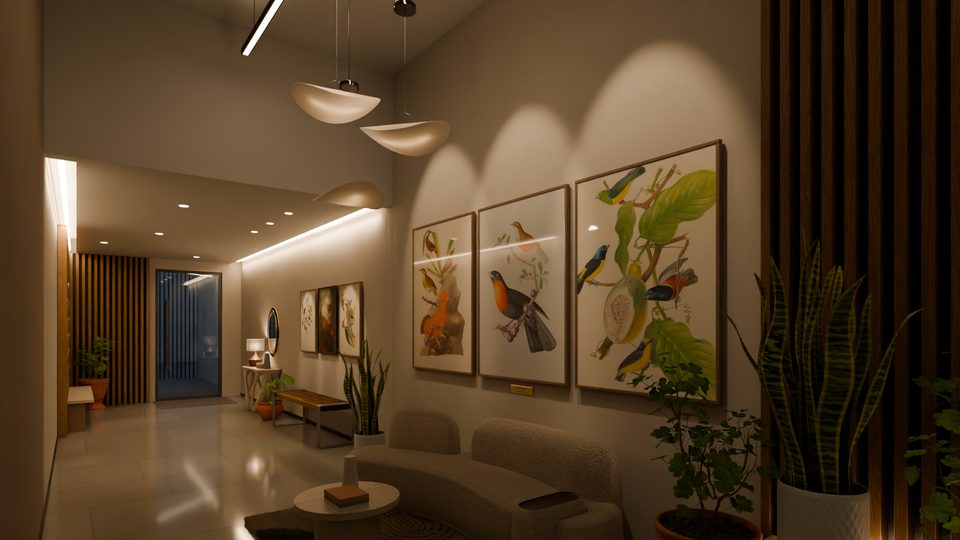 Estar do hall de entrada do Sabiá Living: sofá curvo de bouclé, mesa redonda, três pendentes e as pranchas de aves da floresta na parede, com um sabiá-laranjeira no centro